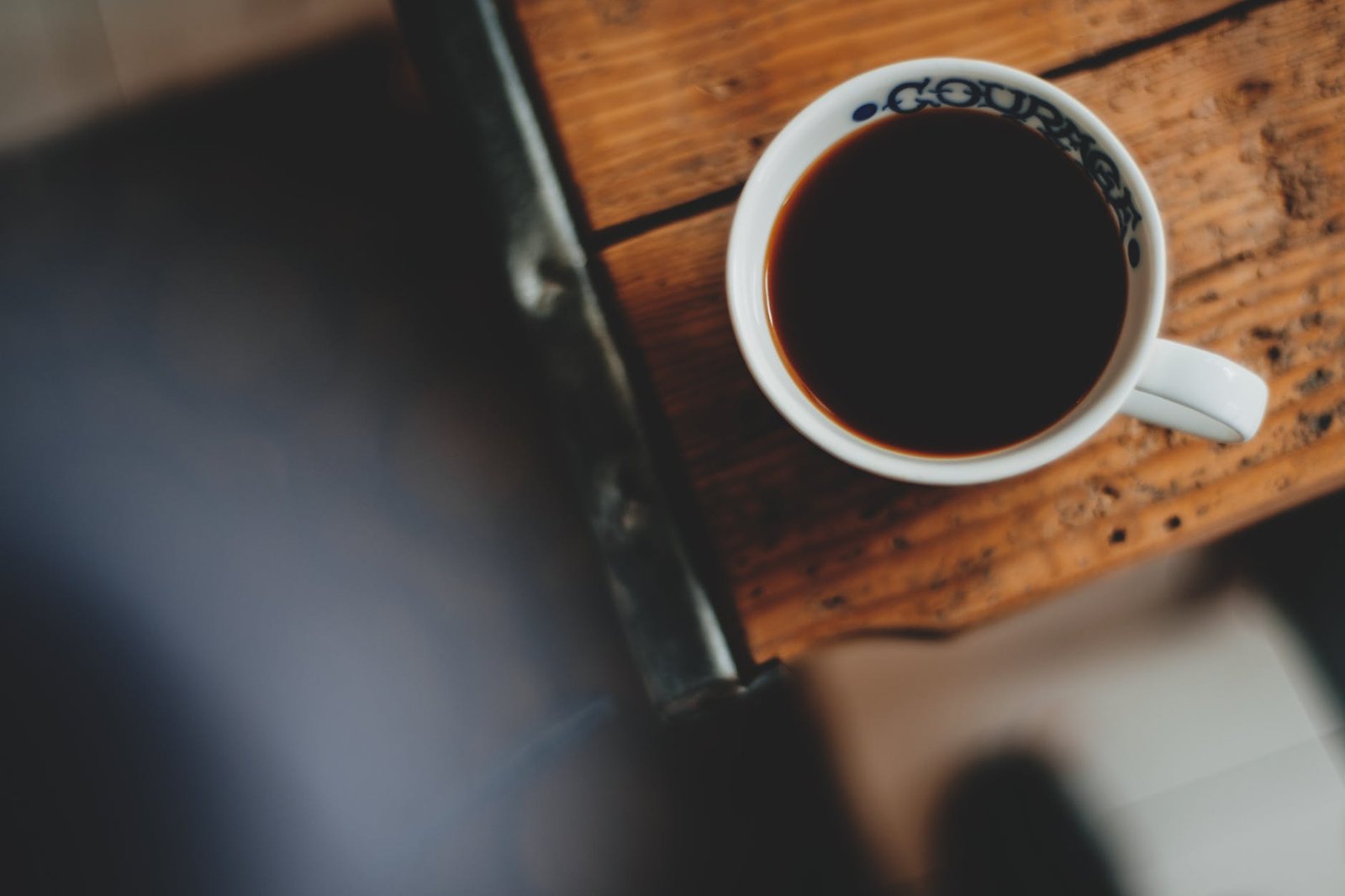 mug of black coffee on wooden table